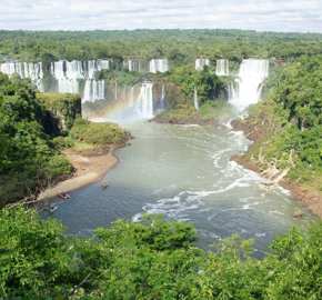 Iguassu Falls thunders through Brazil's rainforest in a sweeping panoramic view. 