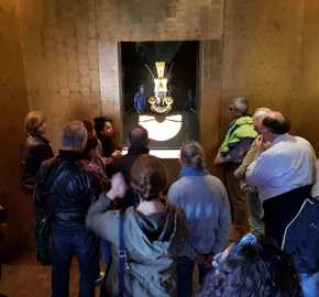 Tourists viewing an ancient golden mask exhibit in a museum in Lima, Peru. 